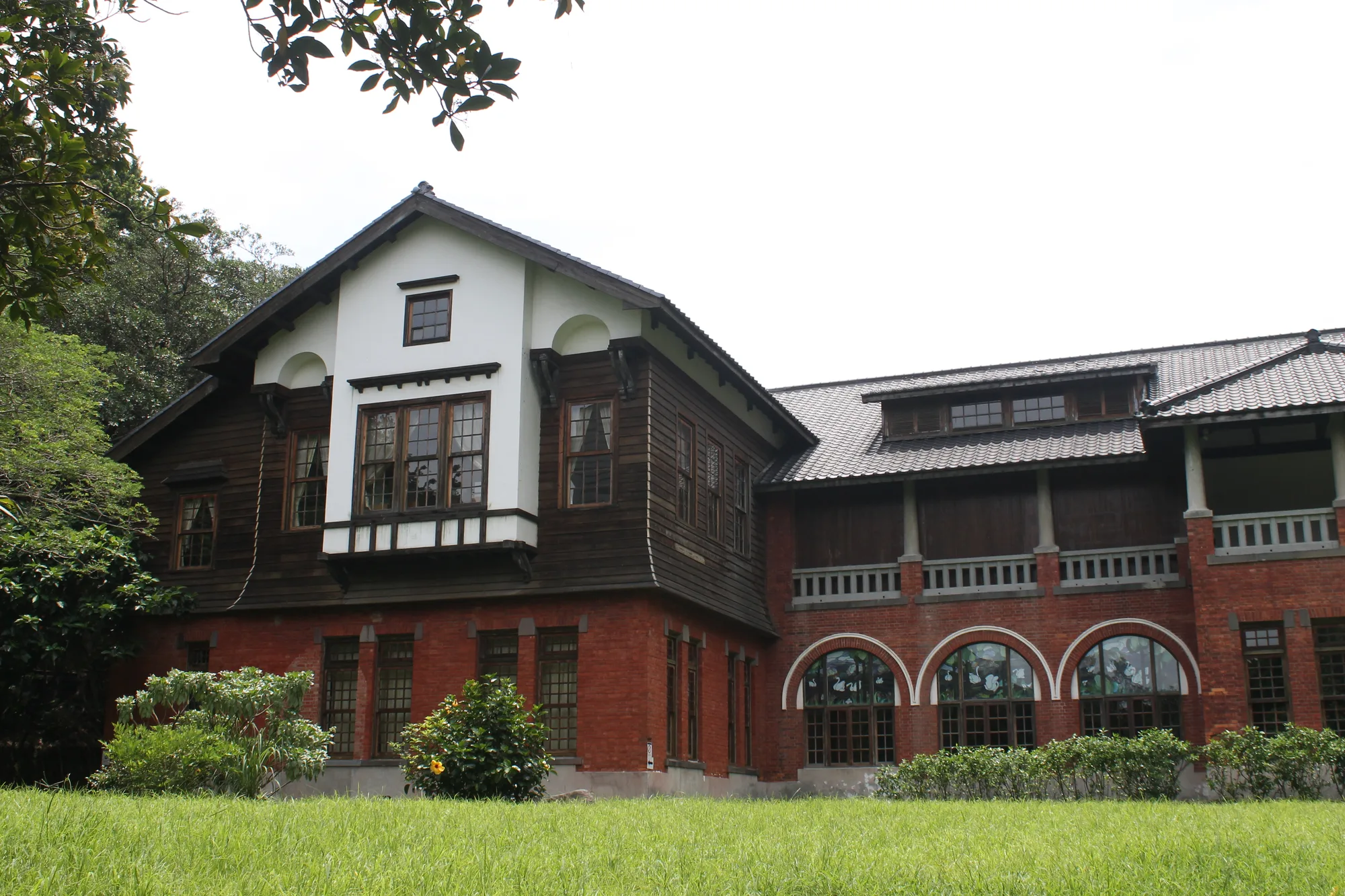 The historic Beitou Hot Spring Museum bathhouse in Taipei, with a red-brick lower storey and dark timber upper storey