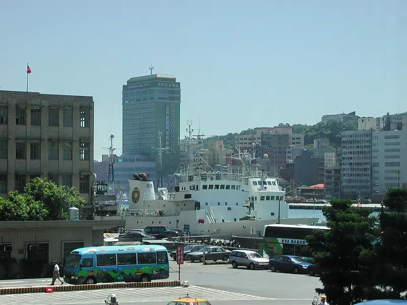 Keelung Harbour in northern Taiwan with a docked ship and the city rising up the green hillside behind